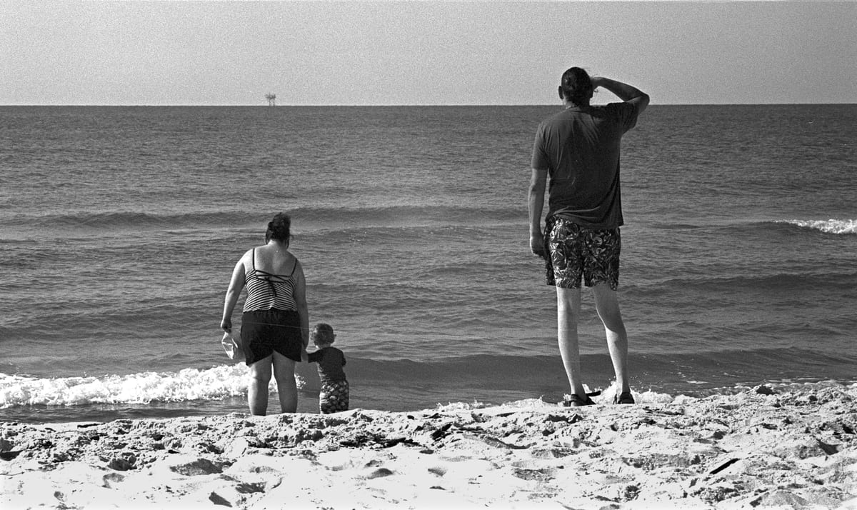 Christian Katie Ben looks out at oil rig 1